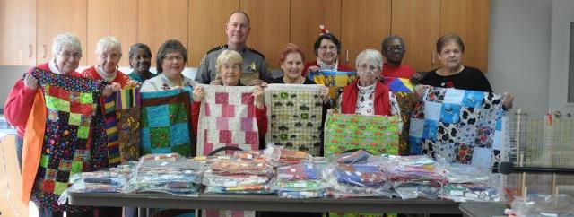 Foxxi Lady Quilters Group pic with Sheriff Websize.jpg